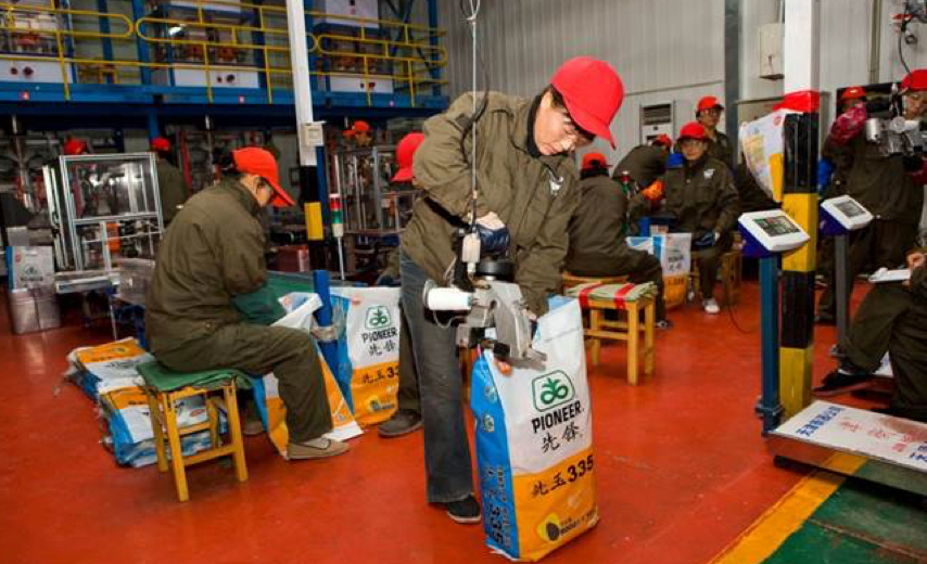 Chinese Pioneer workers in factory